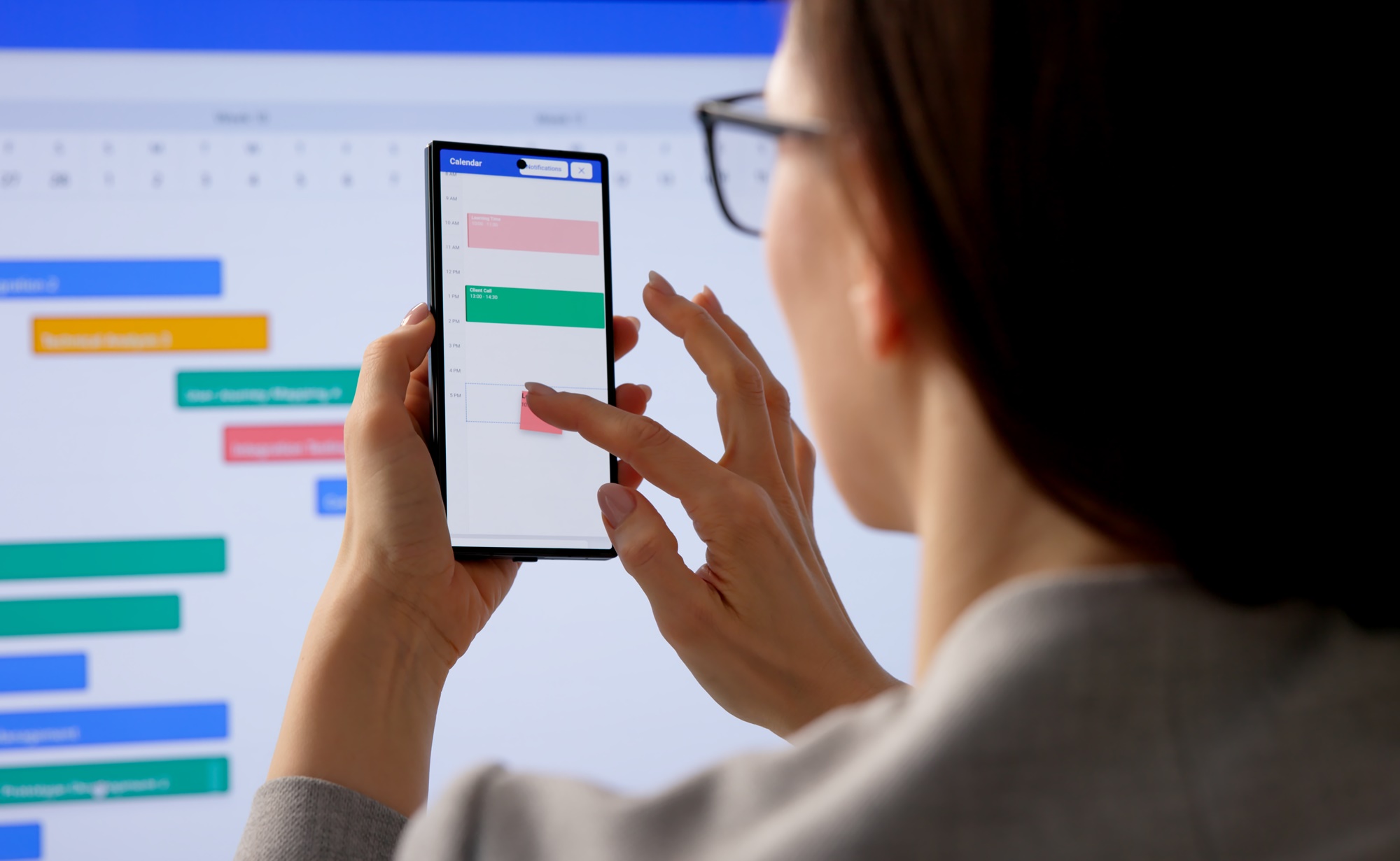 Kobieta planująca spotkania w kalendarzu na smartfonie